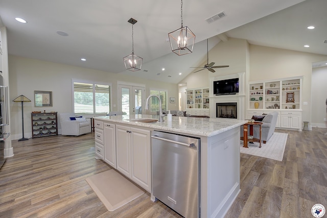 8907 River Ridge Drive, Texarkana, TX 75503 - kitchen with dishwasher, a sink, open floor plan, a ceiling fan, and a fireplace