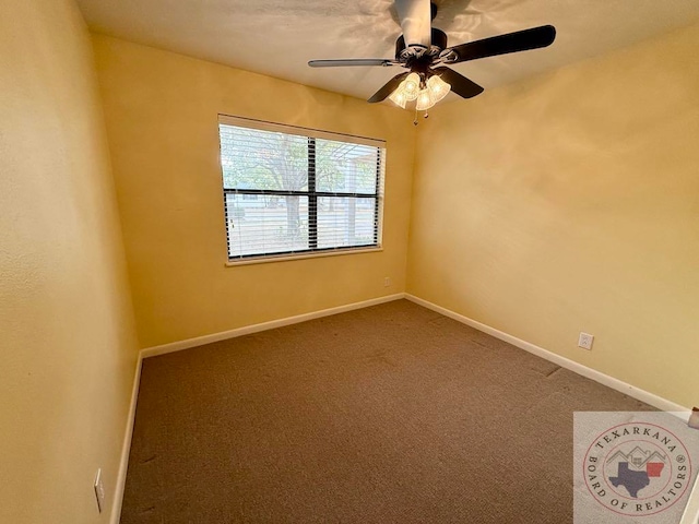 unfurnished room featuring ceiling fan and carpet