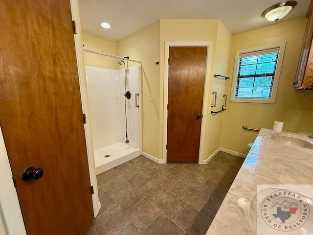 bathroom with a shower and vanity