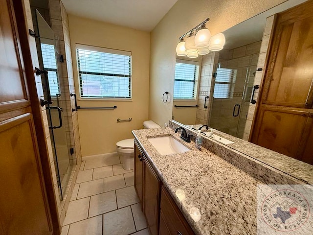 bathroom with vanity, toilet, walk in shower, and tile patterned floors