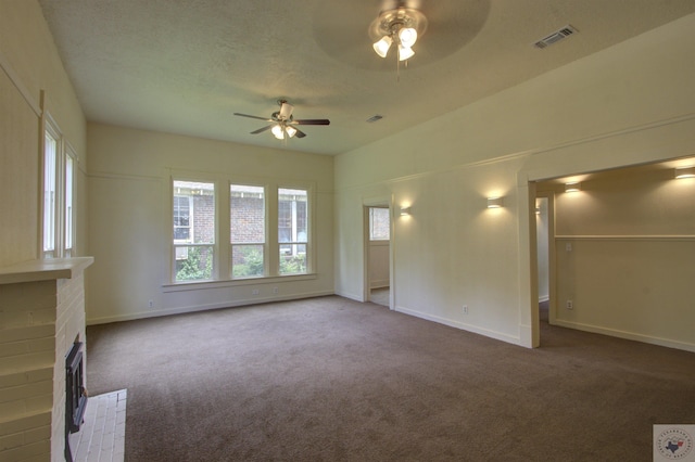 unfurnished living room with carpet floors, a wealth of natural light, ceiling fan, and a fireplace