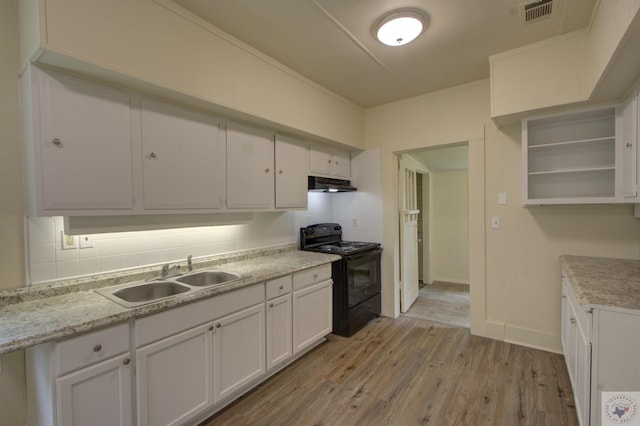 kitchen with white cabinets, black range with electric cooktop, decorative backsplash, sink, and light hardwood / wood-style flooring