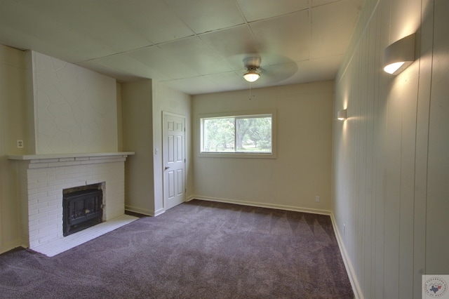 unfurnished living room featuring a fireplace, carpet floors, and ceiling fan