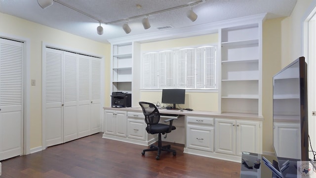 office area with visible vents and dark wood-type flooring