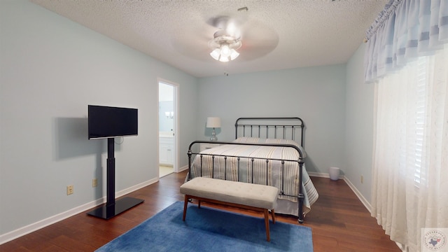 bedroom with baseboards, a textured ceiling, and wood finished floors