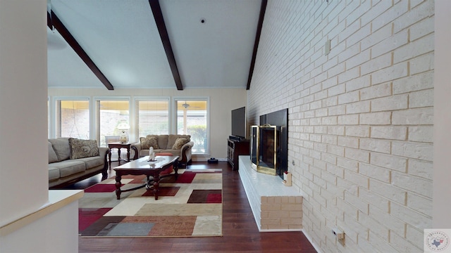 living area with baseboards, brick wall, lofted ceiling with beams, a fireplace, and dark wood-type flooring