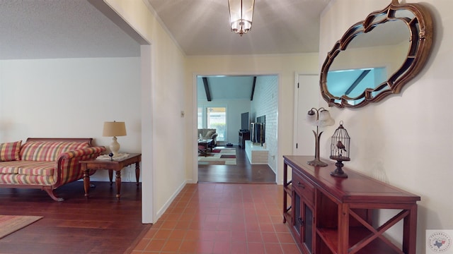 entrance foyer with dark wood-type flooring, baseboards, and beam ceiling