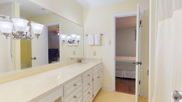 full bathroom featuring vanity, ornamental molding, tile patterned flooring, ensuite bathroom, and a notable chandelier