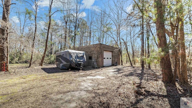 view of outbuilding featuring an outbuilding and dirt driveway