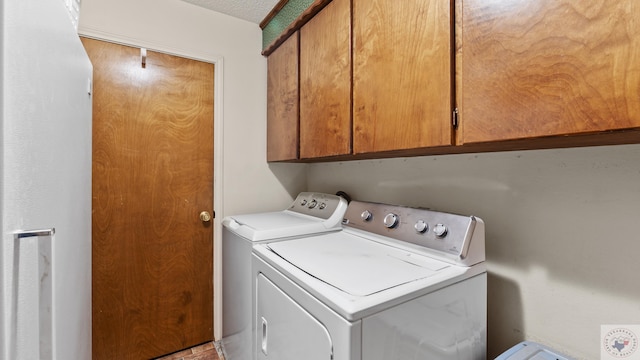 laundry room with washer and clothes dryer and cabinet space