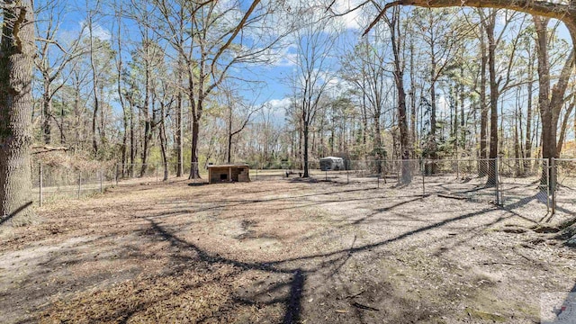 view of yard with an outbuilding and fence