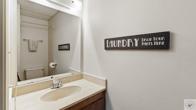 half bath with vanity and toilet