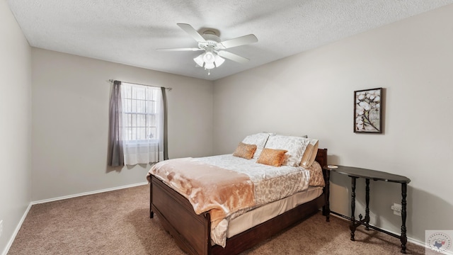 bedroom featuring carpet, baseboards, ceiling fan, and a textured ceiling