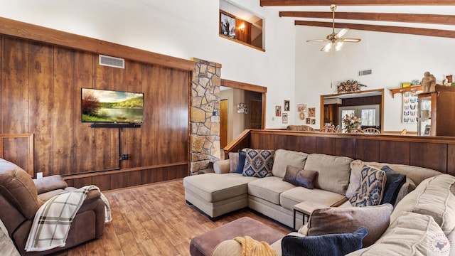 living room featuring high vaulted ceiling, visible vents, beam ceiling, and wood finished floors