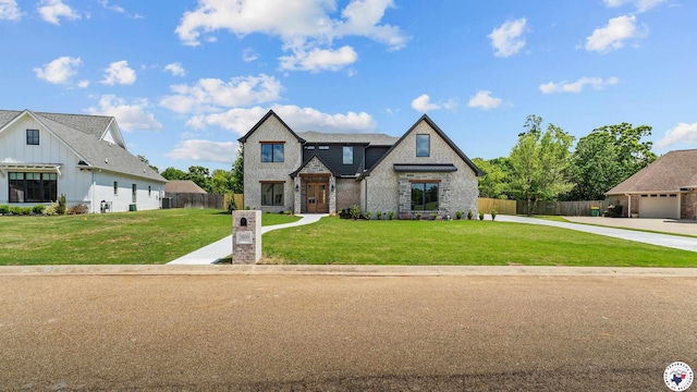 view of front of property with brick siding, a front lawn, fence, and driveway