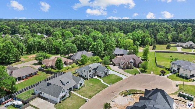 drone / aerial view with a residential view and a wooded view