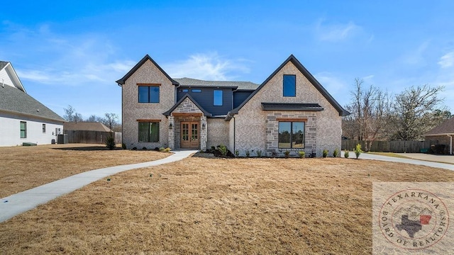 view of front of house with brick siding and fence