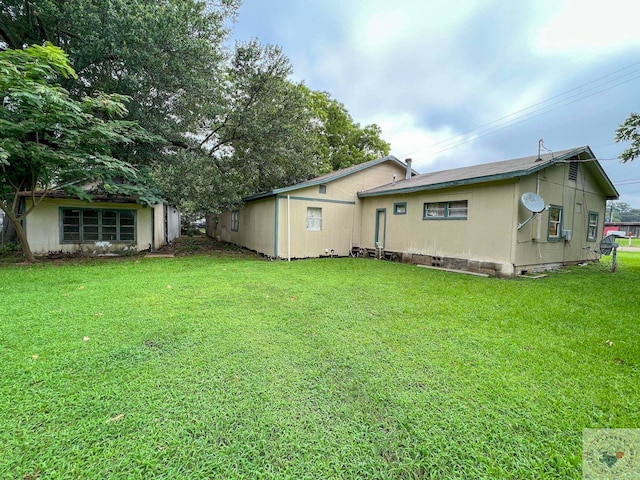 rear view of property featuring a yard