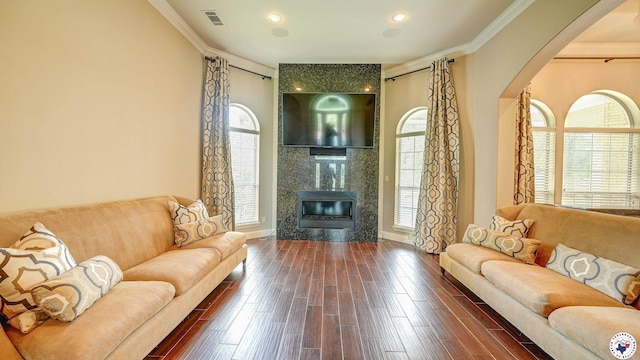 1067 Beaver Lake Dr, Texarkana, TX 75501 - living area with arched walkways, dark wood-style flooring, ornamental molding, a premium fireplace, and baseboards