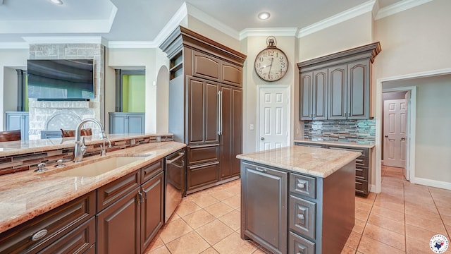 1067 Beaver Lake Dr, Texarkana, TX 75501 - kitchen with a sink, dishwasher, light tile patterned floors, light stone countertops, and crown molding