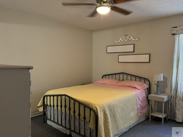 carpeted bedroom featuring ceiling fan and a textured ceiling