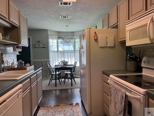 kitchen with sink, white appliances, pendant lighting, and decorative backsplash