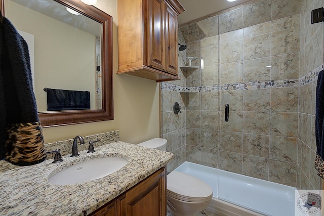 bathroom with toilet, a shower with shower door, and vanity