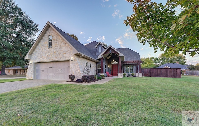 view of front of home featuring a front yard and a garage