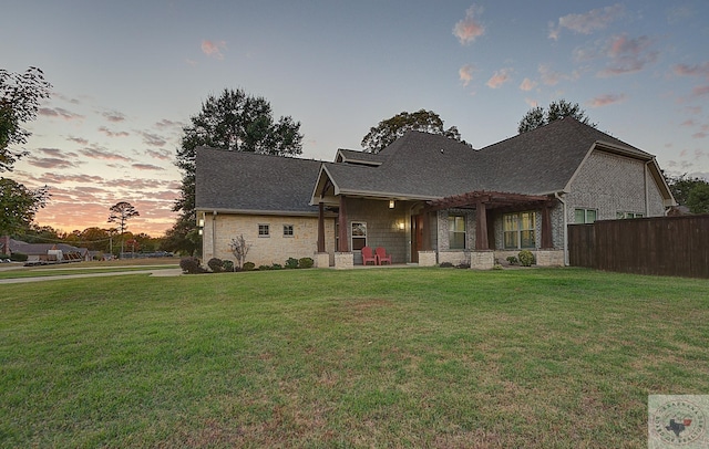 3206 Wyatt Ln, Texarkana, TX 75503 - view of front of home with a shingled roof, fence, a front yard, stone siding, and a pergola