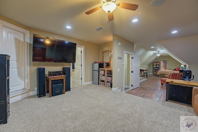 living room with ceiling fan, vaulted ceiling, and carpet floors