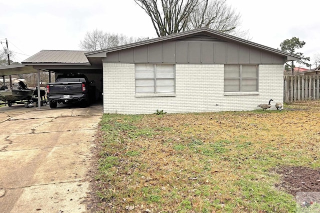 view of home's exterior featuring a lawn and a carport