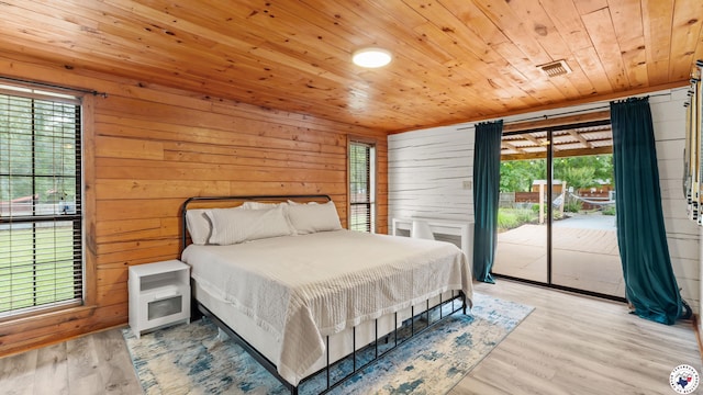 77 Big Rock Cir, Texarkana, AR 71854 - bedroom with wooden ceiling, access to outside, multiple windows, wooden walls, and wood finished floors