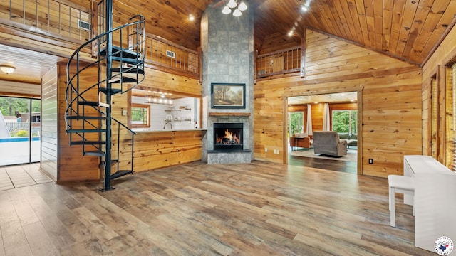 77 Big Rock Cir, Texarkana, AR 71854 - unfurnished living room with high vaulted ceiling, wooden walls, wood ceiling, stairway, and wood finished floors