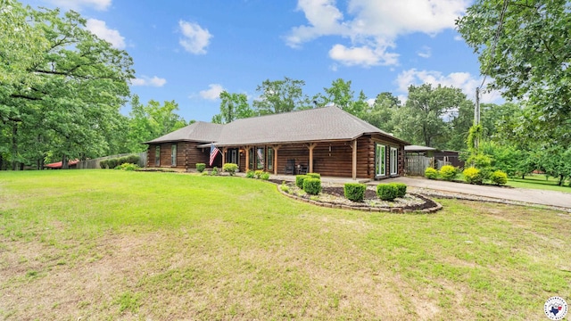 77 Big Rock Cir, Texarkana, AR 71854 - cabin with log exterior, concrete driveway, view of scattered trees, and covered porch