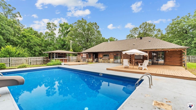77 Big Rock Cir, Texarkana, AR 71854 - view of pool with a water slide, a deck, a fenced backyard, and view of wooded area