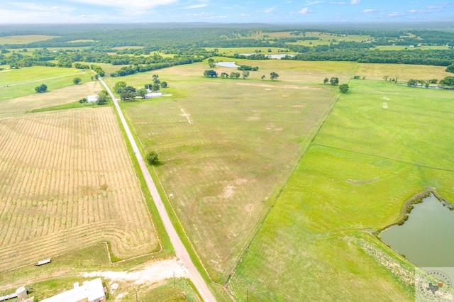 birds eye view of property with a water view and a rural view