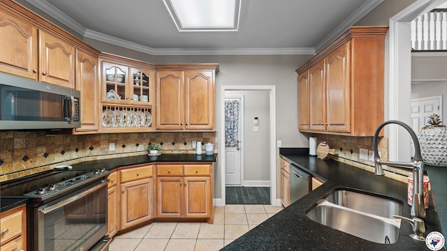 13 Whitney Cir, Texarkana, TX 75503 - kitchen featuring appliances with stainless steel finishes, light tile patterned floors, backsplash, dark stone counters, and brown cabinetry