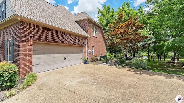 13 Whitney Cir, Texarkana, TX 75503 - view of property exterior with brick siding, a shingled roof, driveway, and an attached garage