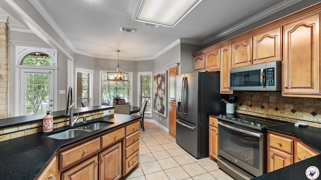 13 Whitney Cir, Texarkana, TX 75503 - kitchen featuring stainless steel appliances, light tile patterned floors, tasteful backsplash, hanging light fixtures, and crown molding