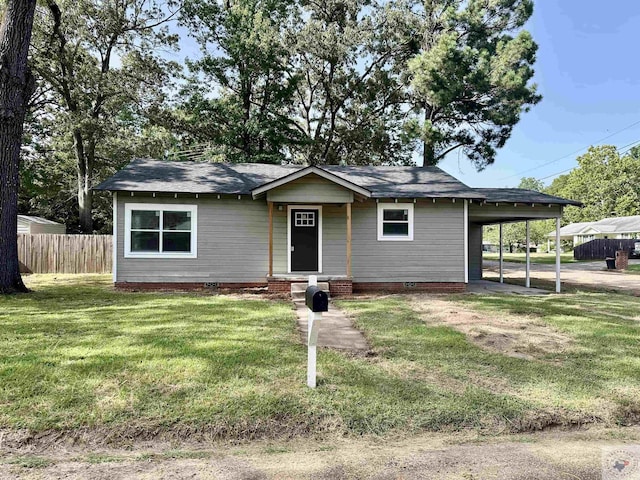 view of front of house with a front yard and a carport