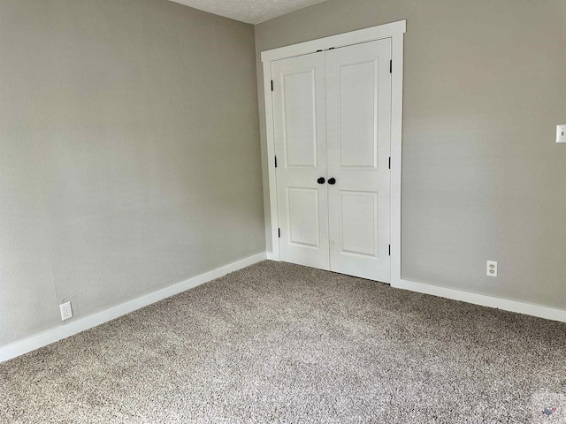 unfurnished bedroom with a closet and carpet