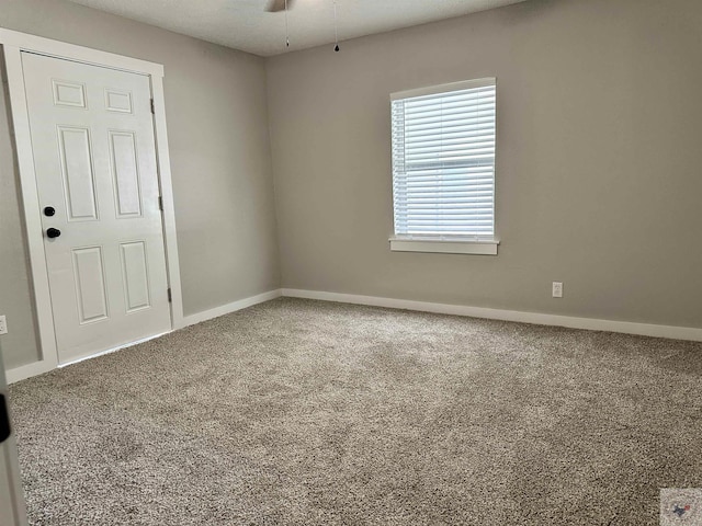 carpeted empty room with ceiling fan