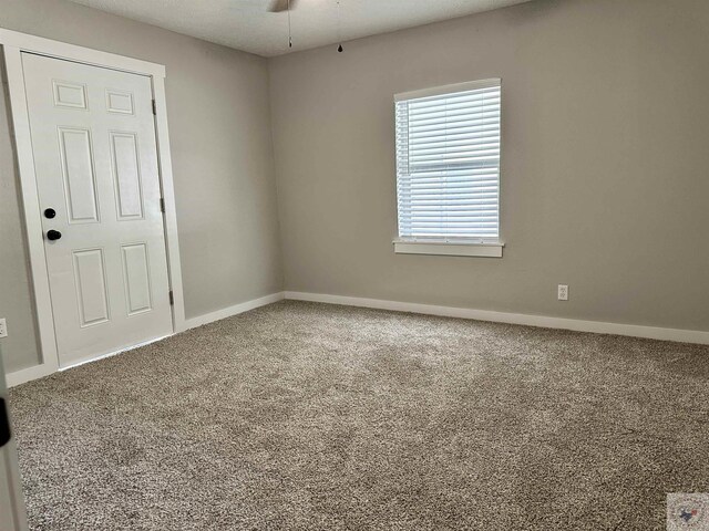 carpeted empty room with ceiling fan