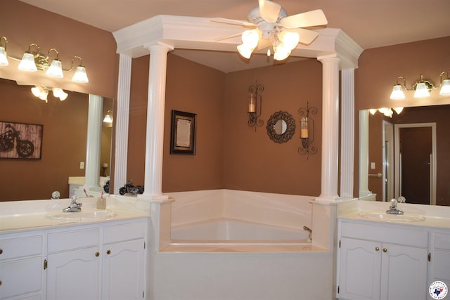 6002 Forest Bnd, Texarkana, AR 71854 - bathroom featuring decorative columns, two vanities, a bath, and a ceiling fan