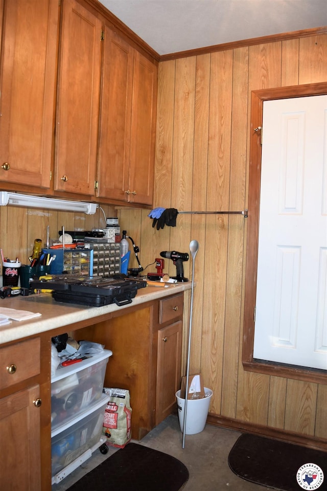 6002 Forest Bnd, Texarkana, AR 71854 - kitchen with brown cabinets, light countertops, and wooden walls