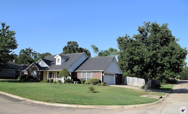 6002 Forest Bnd, Texarkana, AR 71854 - new england style home featuring an attached garage, brick siding, concrete driveway, and a porch