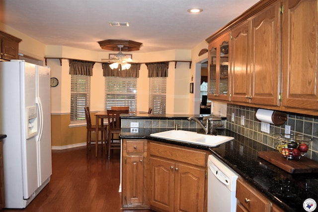 6002 Forest Bnd, Texarkana, AR 71854 - kitchen featuring white appliances, a ceiling fan, a peninsula, dark wood-type flooring, and brown cabinets