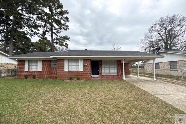 single story home with a front yard and a carport