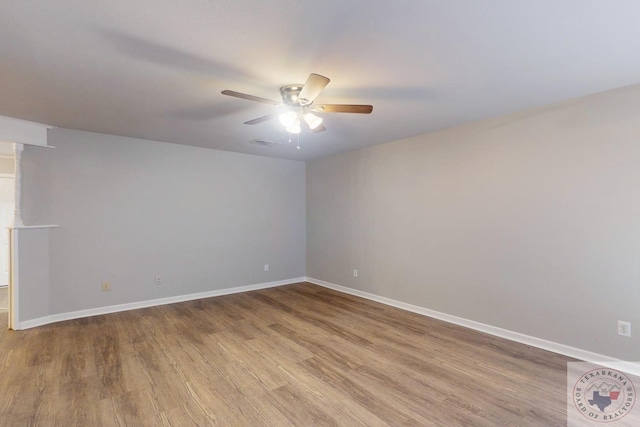 spare room featuring ceiling fan and light hardwood / wood-style floors