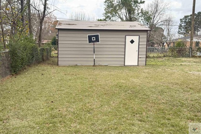 view of outbuilding with a yard